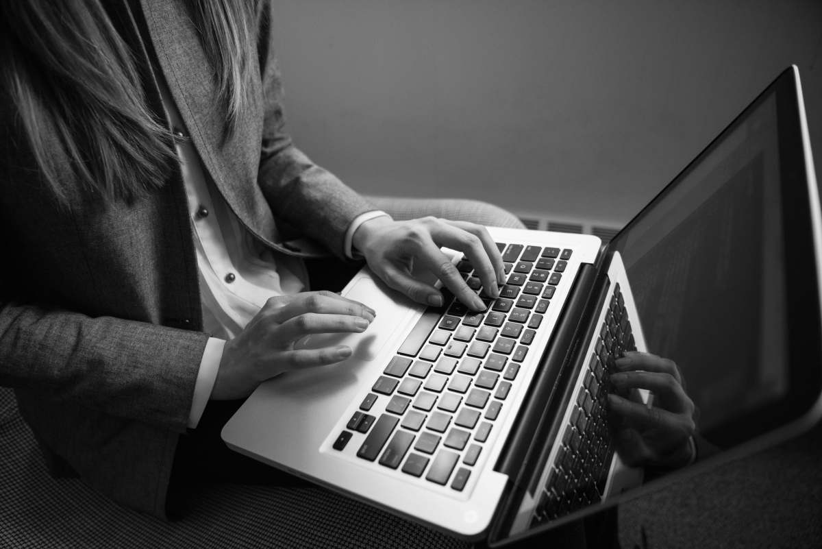 software developer grayscale photography of woman typing on a laptop software engineer